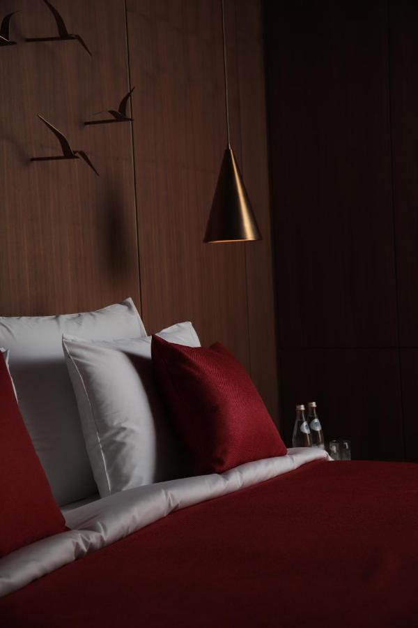 The Veil Hotel Astana Extérieur photo A bed with a red pillow