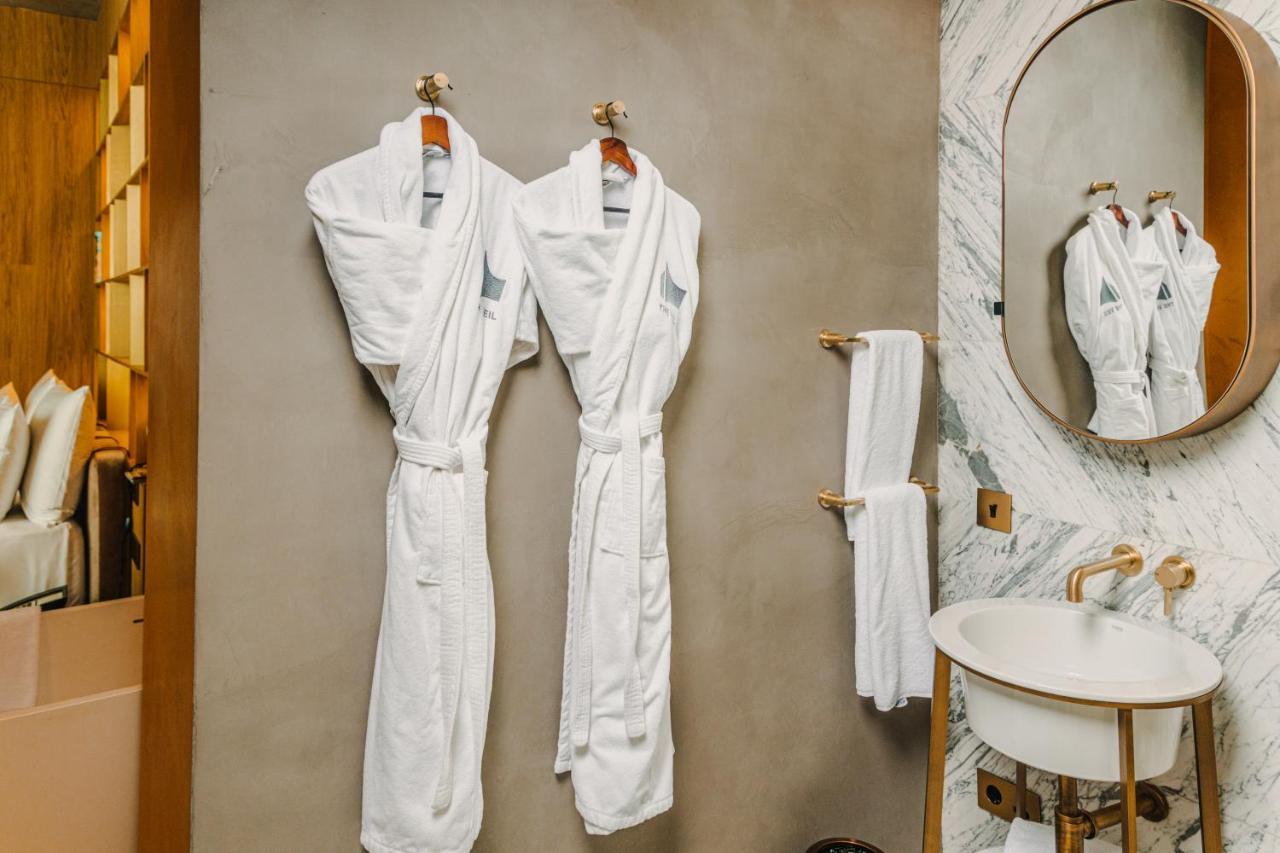 The Veil Hotel Astana Extérieur photo Bathrobes in a hotel bathroom